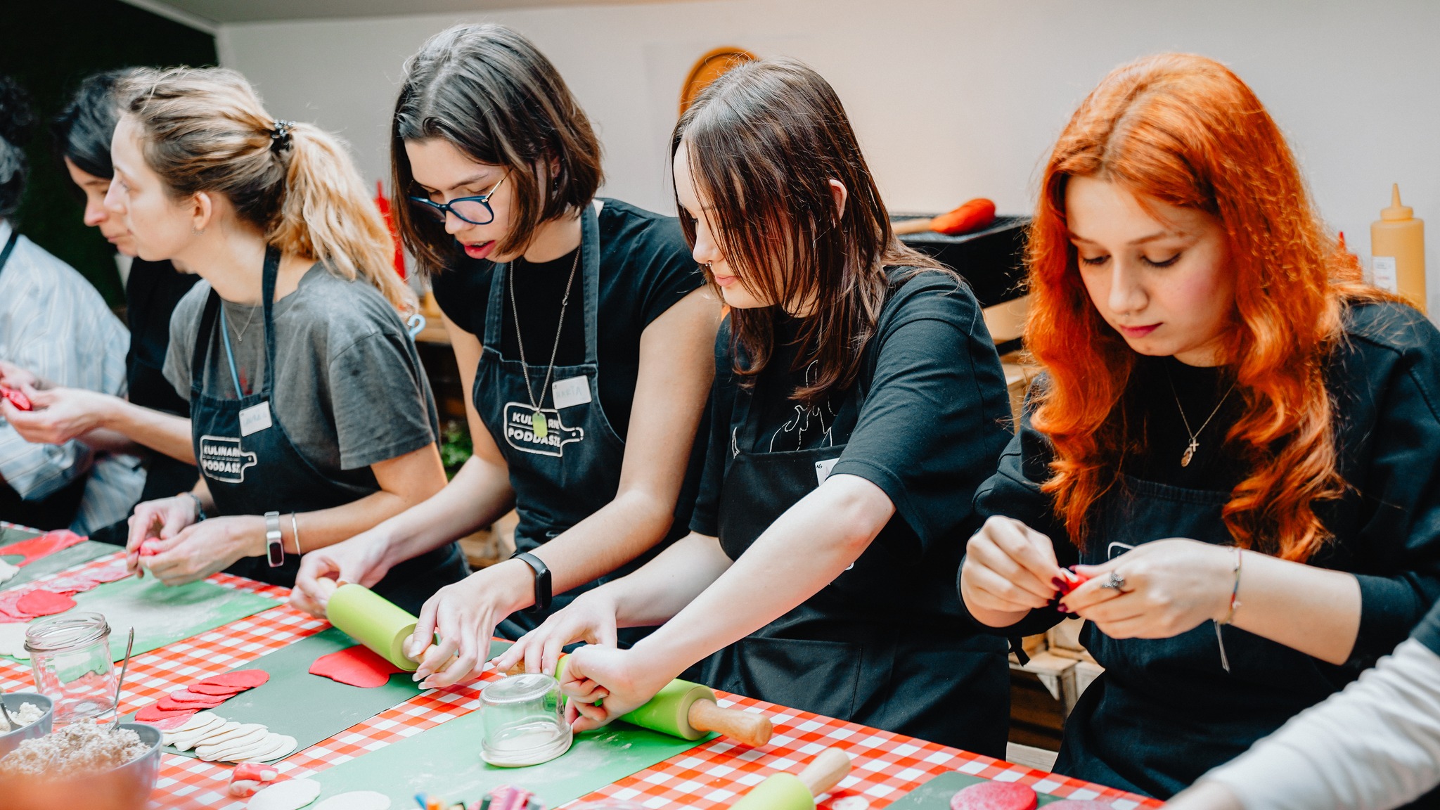Students learning to make dumplings during a cooking workshop.